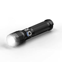 Black flashlight with a white light on a white background