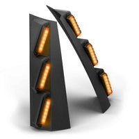 Pair of black Feniex Quantum® 2.0 Pillar with orange LED lights on a white background