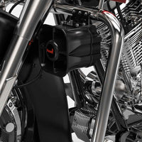 Close-up of a motorcycle engine with a Feniex Titan 30W Speaker/Siren, featuring the brand 'Feniex'.