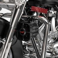 Close-up of a motorcycle engine with Feniex Titan 30W Speaker/Siren fitted