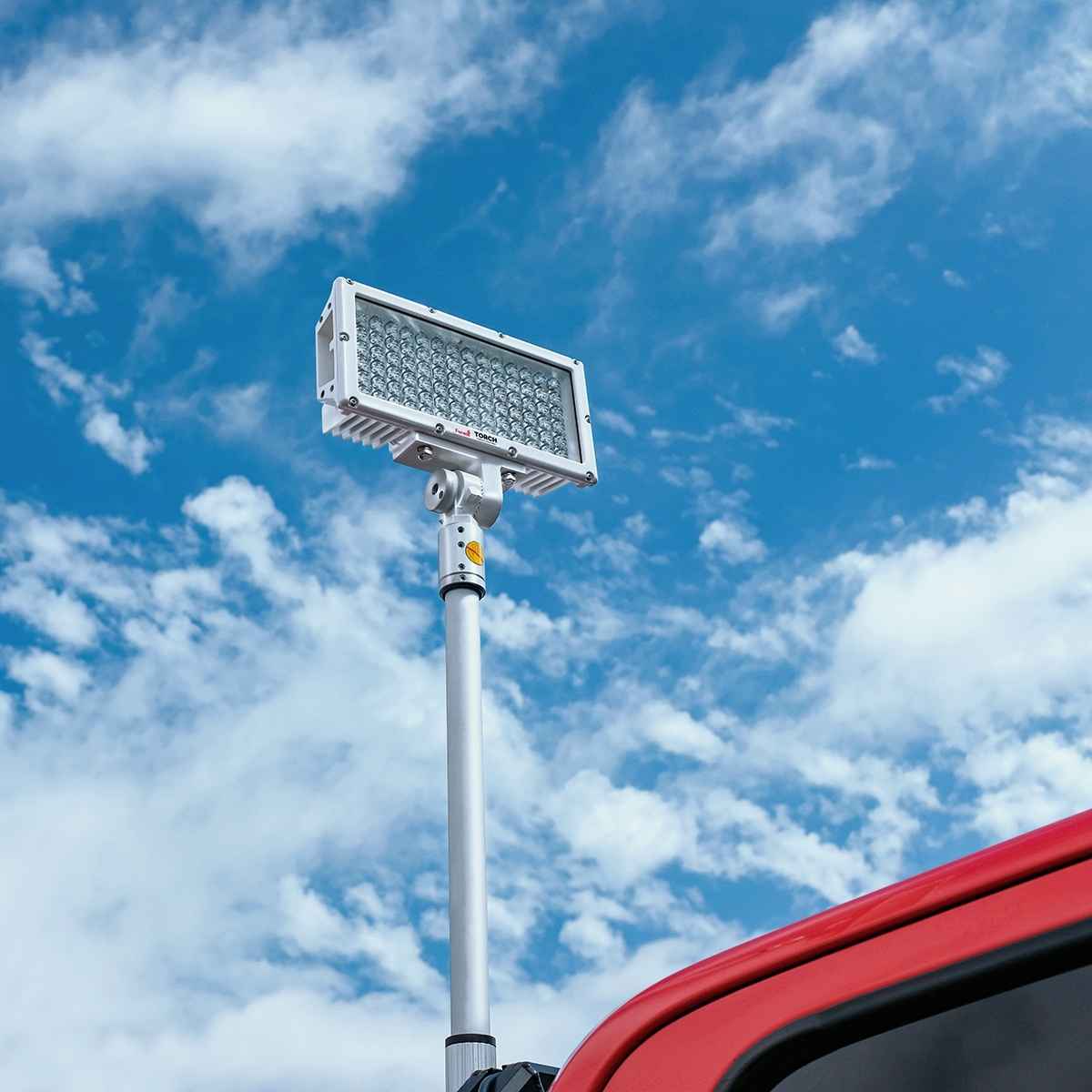 Feniex Torch Pole Light on a pole against a blue sky with clouds