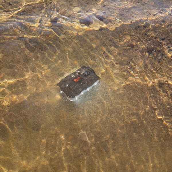 Guardian Angel Micro Series Device and Accessory Kayak/Marine Kit - RF device with red light partially submerged in clear water