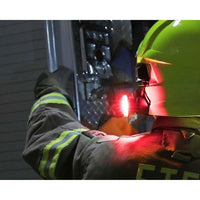 Person wearing a high-visibility jacket and Guardian Angel - Fire Helmet Mount with reflective stripes, working on machinery.