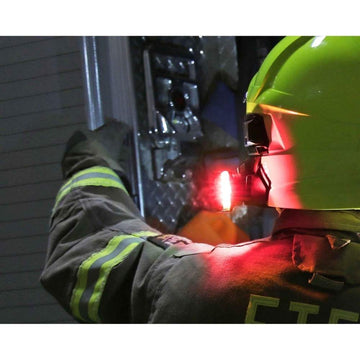 Person wearing a high-visibility jacket and Guardian Angel - Fire Helmet Mount with reflective stripes, working on machinery.