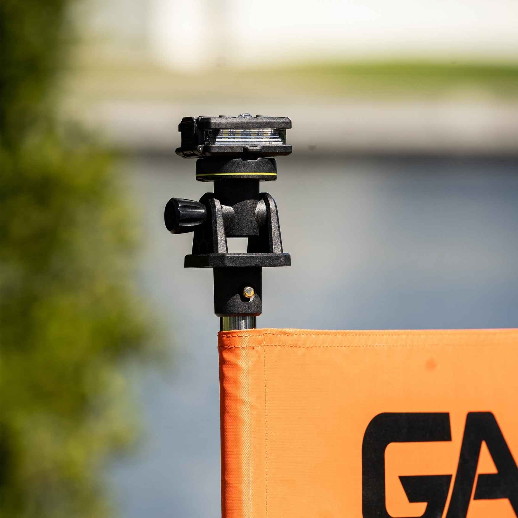Camera mount on an orange flag with 'GA' branding, blurred background