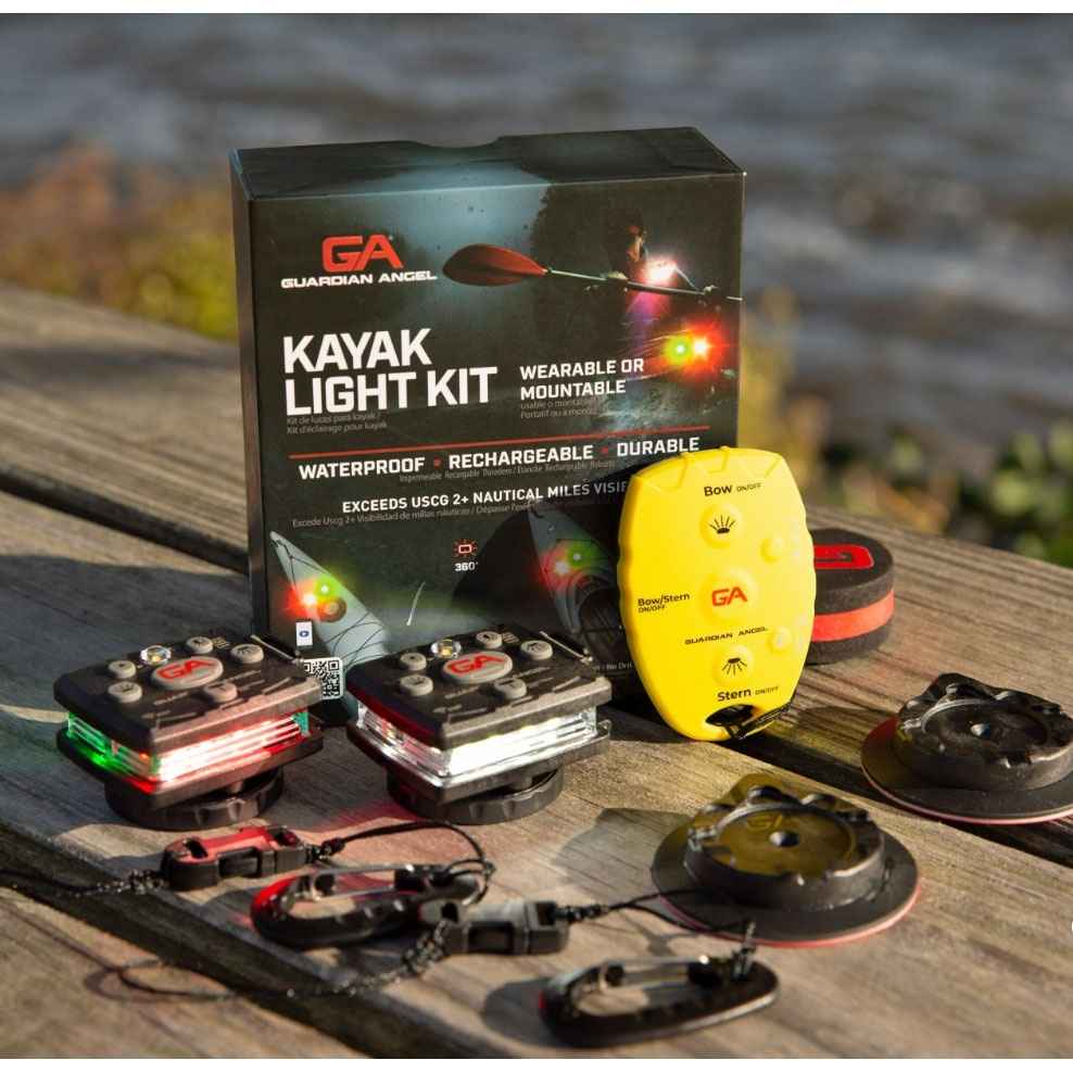 Guardian Angel kayak light kit with packaging on a wooden surface by a body of water.
