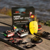 Guardian Angel kayak light kit with packaging on a wooden surface by a body of water.