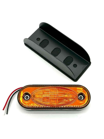 Orange LED marker light with black housing on a white background