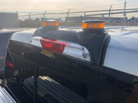 Tail lights and emergency lights on a vehicle with a blurred background