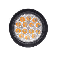Round LED light with black rim and orange and clear lens on a white background