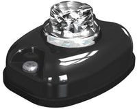 Black LED light with clear crystal-like top on a white background