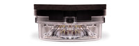 Car headlight with clear lens and black casing on a white background