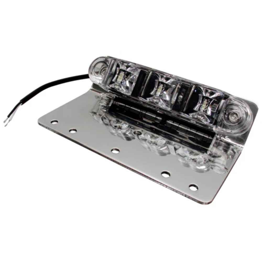 A silver TecNiq E10 ground/pump panel light featuring LED illumination, mounted on a flat surface with a wire attached.