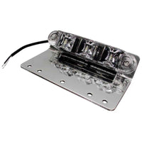 A silver TecNiq E10 ground/pump panel light featuring LED illumination, mounted on a flat surface with a wire attached.