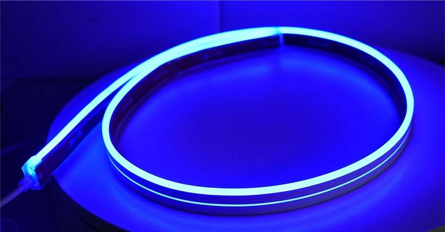 Neon light strip glowing blue on a dark background