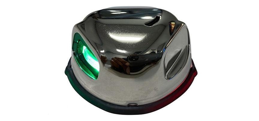 Chrome boat light with green lens on a white background