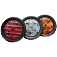 Three round TecNiq T40 : 4" Round Stop/Tail/Turn in red, clear, and orange on a white background
