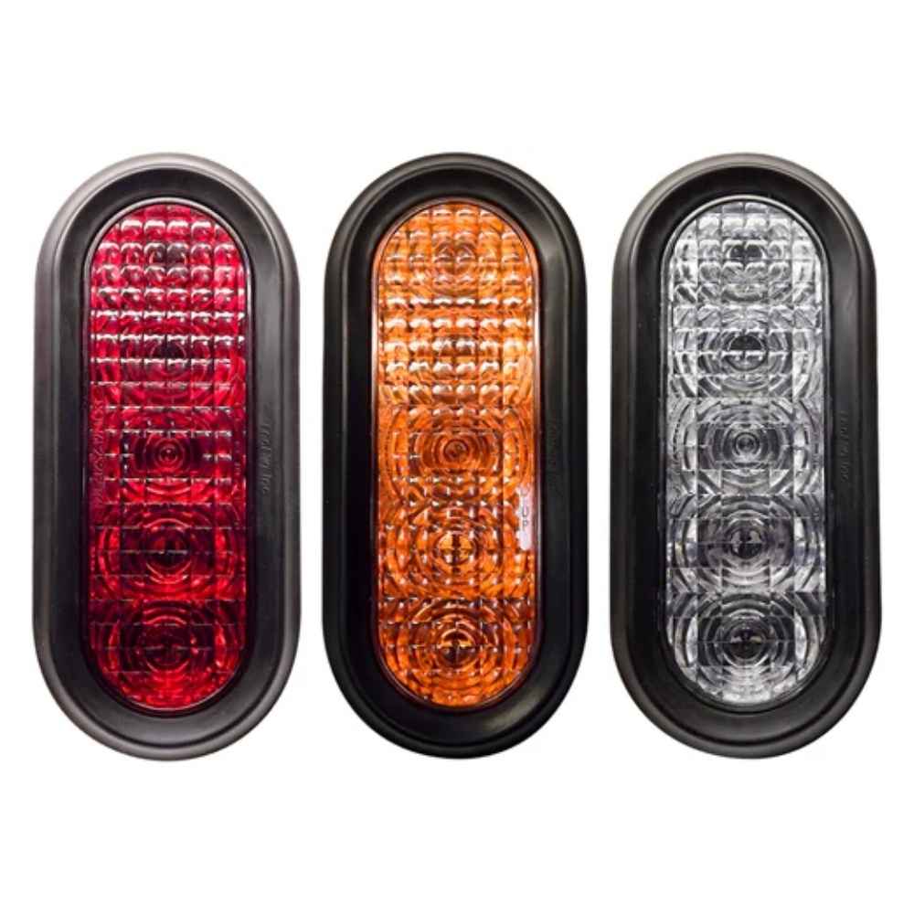 Three TecNiq T60 : 6" Oval Stop/Tail/Turn Grommet Mount in red, orange, and clear on a white background